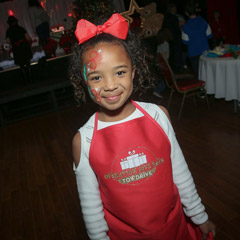 Young girl helping the Lowe team volunteer at Operation Give Back.
